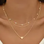 Mehrreihige Herzkette für Damen in Goldfarben mit Herzanhänger und Perlenoptik