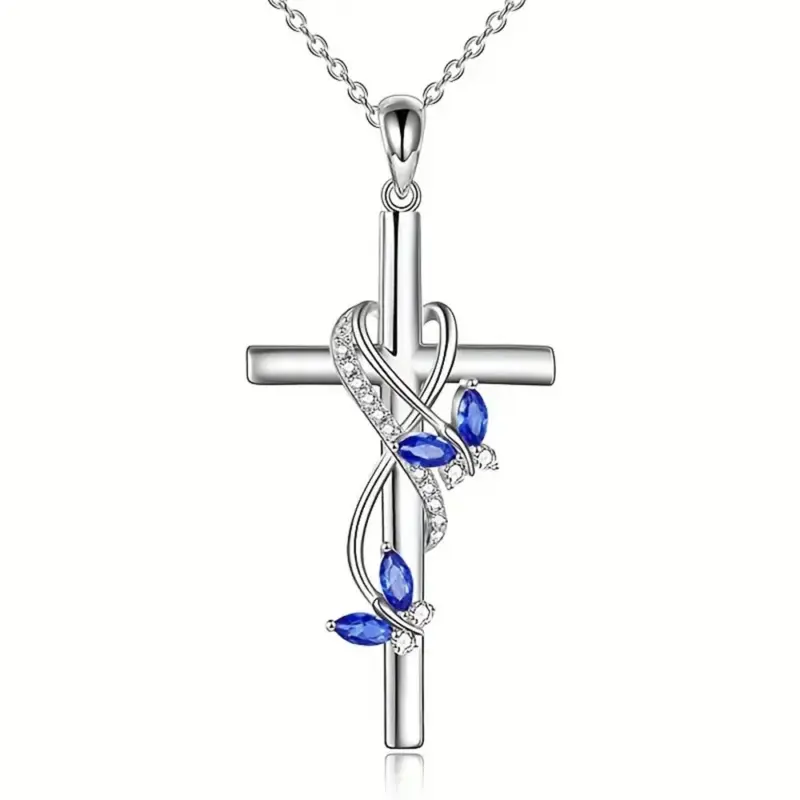 Kreuzanhänger mit blauen Schmetterlingsflügeln und klaren Steinen