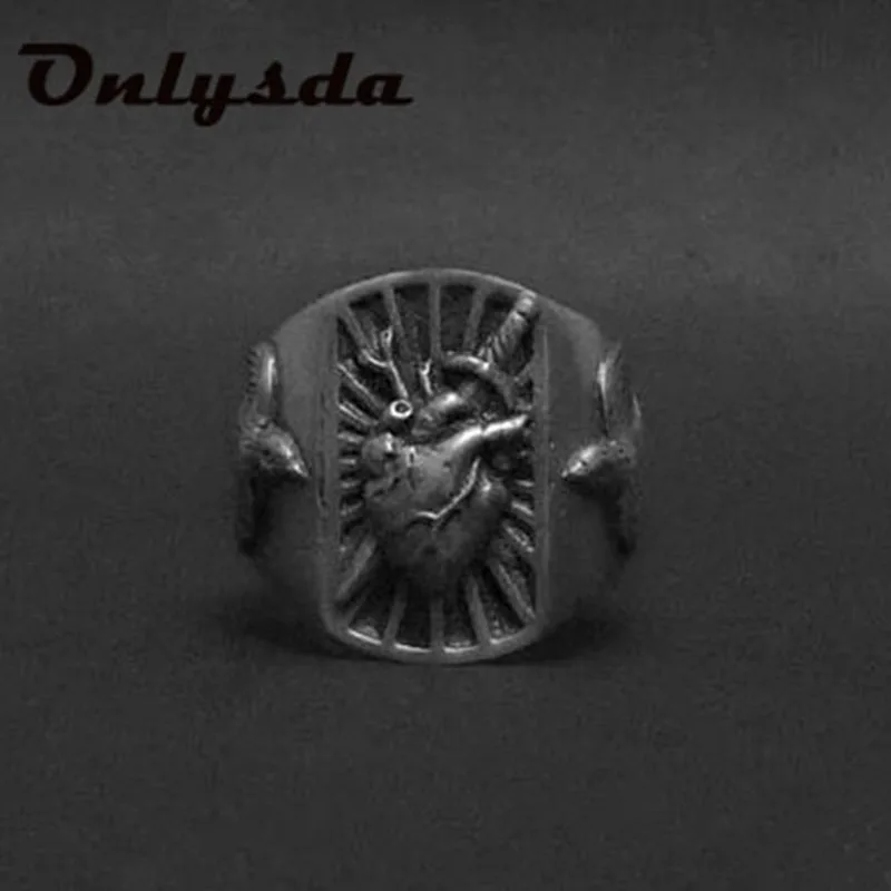 abdo Ring mit anatomischem Herzmotiv und Strahlen auf dunklem Hintergrund