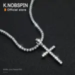 KNOBSPIN Tenniskette mit Moissanit-Kreuz auf dunklem Untergrund