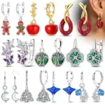 Übersicht mit unterschiedlichen Ohrschmuck-Designs, darunter Lebkuchenfiguren, Äpfel, Schmetterlinge und Kleeblätter