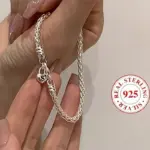 Silberfarbenes Flechtarmband mit Herz-Charm und Buchstabe S, Anbieterabbildung mit 925-Silber-Hinweis