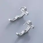Rückseite der Huitan Kreuzcreolen mit geöffneter Klappmechanik und Steinfassungen