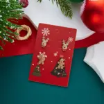 Rentierkopf und glitzernde Lebkuchenfigur als Weihnachtsohrstecker auf roter Motivkarte