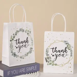 Weiße boomcool Dankeschön-Papiertüten mit Tragegriffen und zwei botanischen Thank-you-Druckmotiven